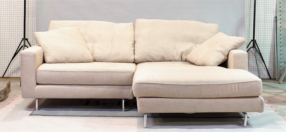 ‘Living Divani’, a modern hardwood framed corner sofa with beige upholstery on chrome tubular...