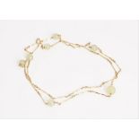 A gold and pale green gemstone bead necklace, the bar and twist link chain spaced with seven...