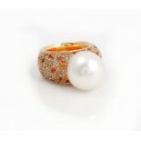 A gold, South Sea cultured pearl, diamond and orange sapphire ring, mounted with the large...