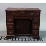 A mid-18th century mahogany kneehole writing desk