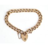 A gold curb link bracelet, detailed 9 C, on a gold heart shaped padlock clasp, detailed 9 C,...