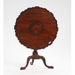 An 18th century Irish mahogany occasional table, the shaped snap top on birdcage mount and...