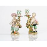 A pair of Derby porcelain candlestick figures, circa 1820-30, modelled as a boy and girl...