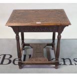 A 17th century style carved oak rectangular occasional table, on turned supports