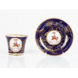 A Chamberlain Worcester armorial blue-ground cup and saucer, circa 1815, each painted with a...