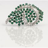 A white gold, diamond and emerald set brooch, designed as a spray, mounted with baguette...