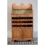 A modern pine side cabinet with three tier wine rack over a cupboard base