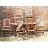 A hardwood rounded rectangular extending garden table with two extra leaves (9).