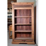 A modern hardwood floorstanding four tier bookcase