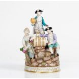 A Meissen group of vintagers, late 19th century, modelled as young woman pouring wine from a...
