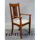 An Arts & Crafts oak open armchair on tapering square supports, 60cm wide; 115cm high.