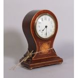 An Edwardian inlaid mahogany balloon shaped mantel clock on brass bun feet