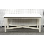 A marble topped rectangular preparation table on white painted block supports, united by X...