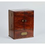 An early 19th century mahogany apothecary cabinet, with a pair of doors over drawer, both...