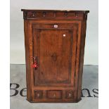 A George III mahogany banded oak hanging corner cupboard