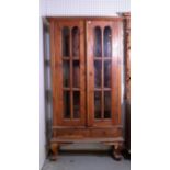 A modern hardwood display cabinet with two short drawers