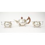 A silver three piece tea set.