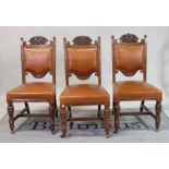 A set of six Victorian oak dining chairs with brown leather upholstery