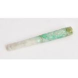 A carved jade cigarette holder.