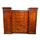 A 19th century mahogany sentry wardrobe with a pair of hanging cupboards, flanking six long...