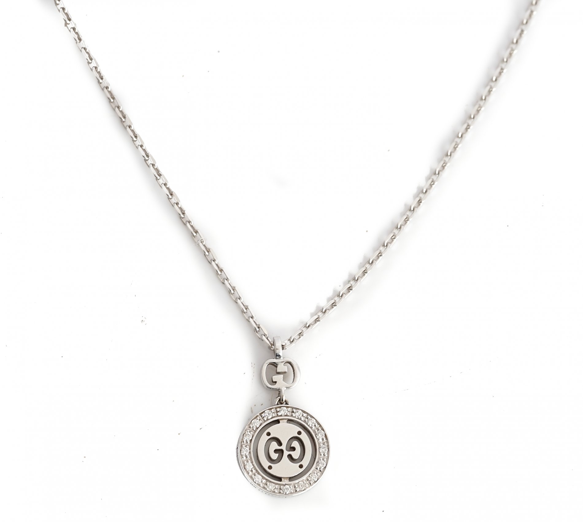 A Gucci white gold and diamond set pendant necklace, the front with a circular drop mounted...