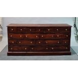 A 20th century hardwood apothecary chest with nineteen various drawers on plinth base