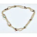 A seed pearl and gem set long necklace