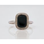 A French platinum, black onyx and diamond ring