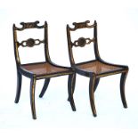 A pair of Regency parcel gilt ebonized side chairs