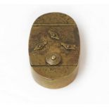 An oval brass three-dial combination lock snuff/tobacco box