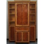 A satinwood birch and burr elm breakfront secretaire bookcase cabinet