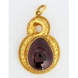 A Victorian gold and carbuncle garnet drop shaped pendant