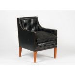 LINLEY; a green leather upholstered Nelson chair with buttoned tufting and a Linley branded...