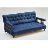 A Victorian parcel gilt ebonised open arm sofa