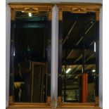 A pair of Regency style parcel gilt ebonised tall rectangular robing mirrors