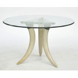 A circular glass topped occasional table