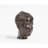 A bronze bust of a young boy