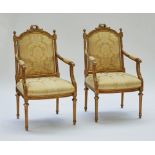 A pair of Louis XVI style gilt framed open armchairs
