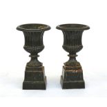 A pair of olive green painted cast iron baluster garden urns