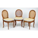 A set of six Louis XV and later caned dining chairs