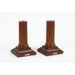 LINLEY LONDON; A pair of mahogany candlesticks