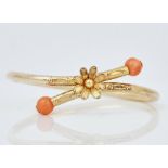 A gold and coral bangle