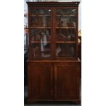 A George III mahogany astragal glazed bookcase cupboard