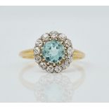 A gold, diamond and aquamarine cluster ring