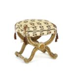 An 18th century French style parcel gilt cream painted x-frame stool