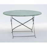 A circular metal garden table