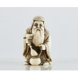 A Japanese ivory netsuke of a bearded old man