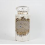 An apothecary glass jar and cover