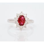 An 18ct white gold, ruby and diamond set cluster ring