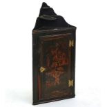 A black lacquer chinoiserie decorated hanging corner cupboard